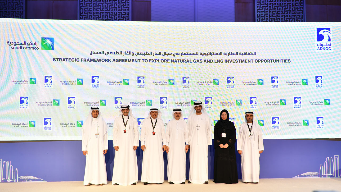 Representatives from Saudi Aramco and ADNOC on the stage at the signing ceremony